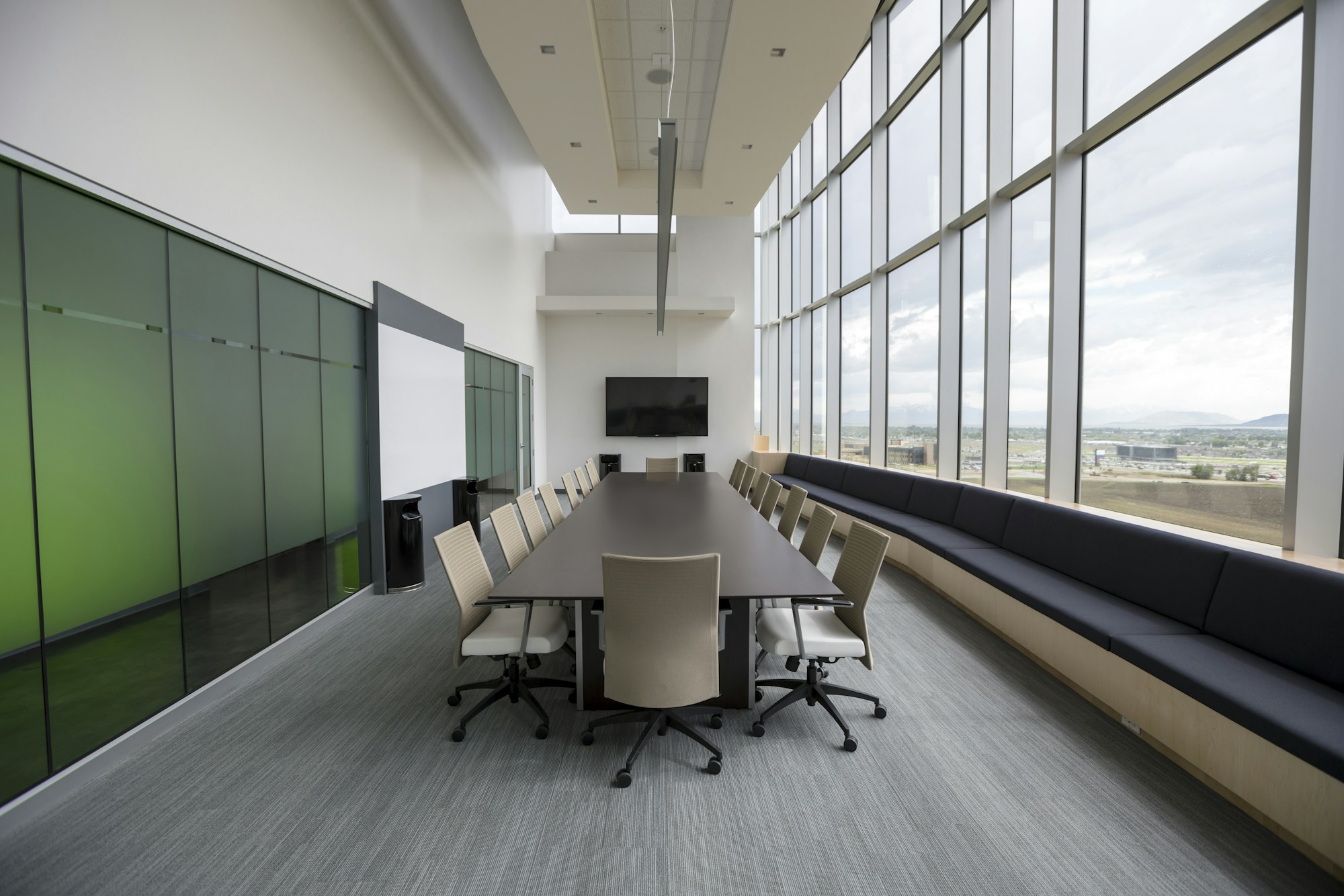 Table de conseil vide entourée de chaises dans une salle de réunion sobre