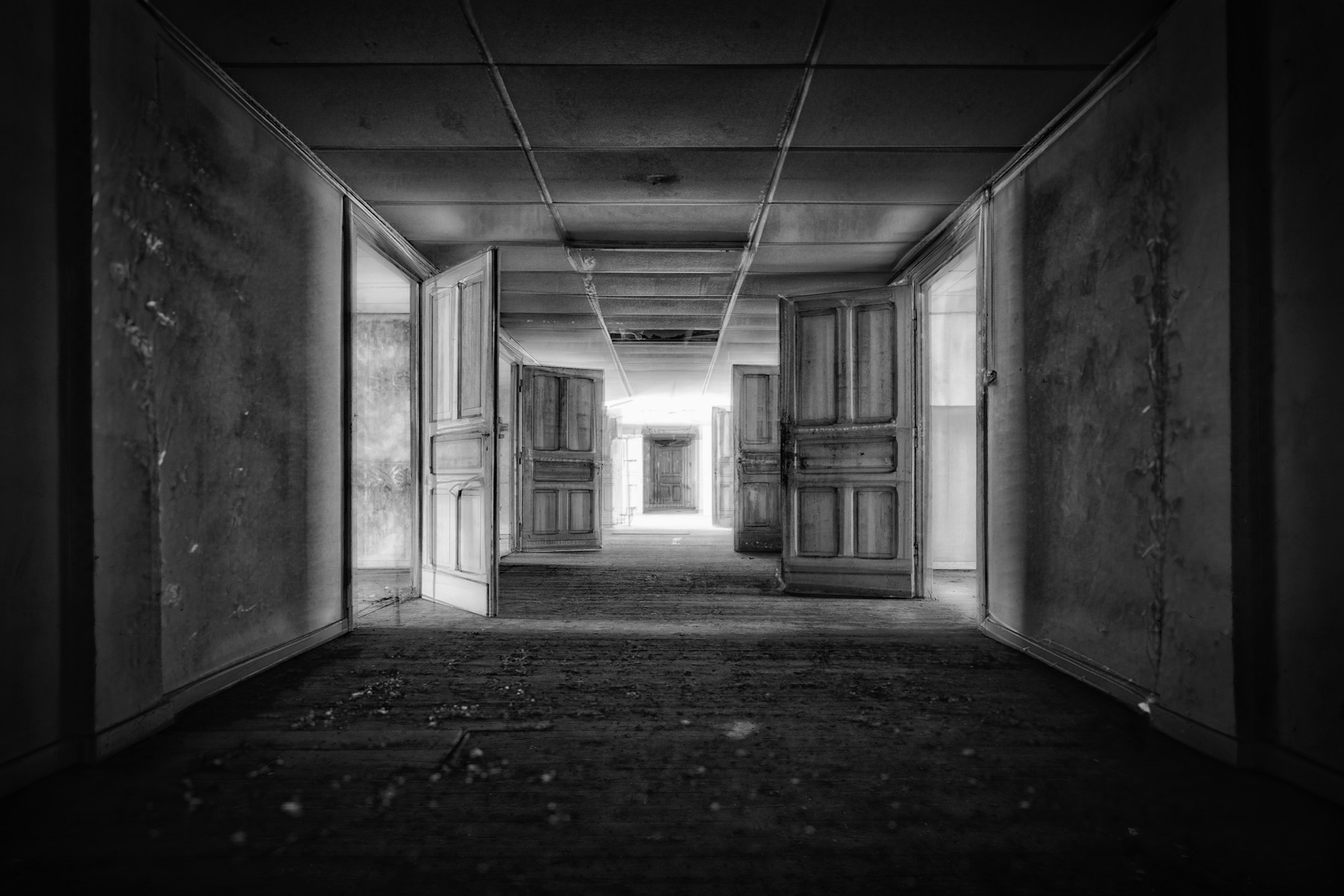 Several open doors along a corridor in perspective