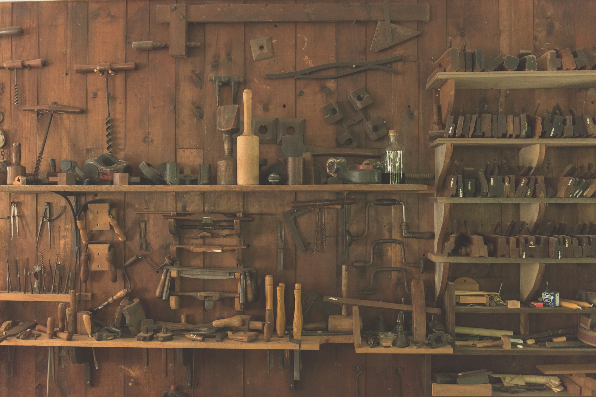 Tools organised on a workshop wall, arranged by size