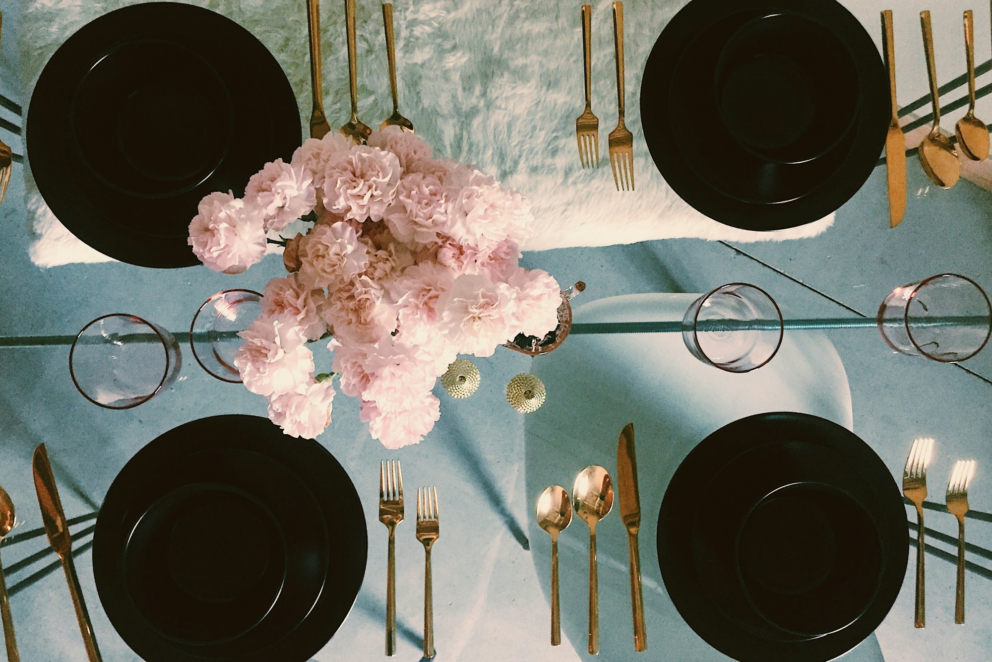 Family dinner table set, viewed from above with plates and cutlery arranged