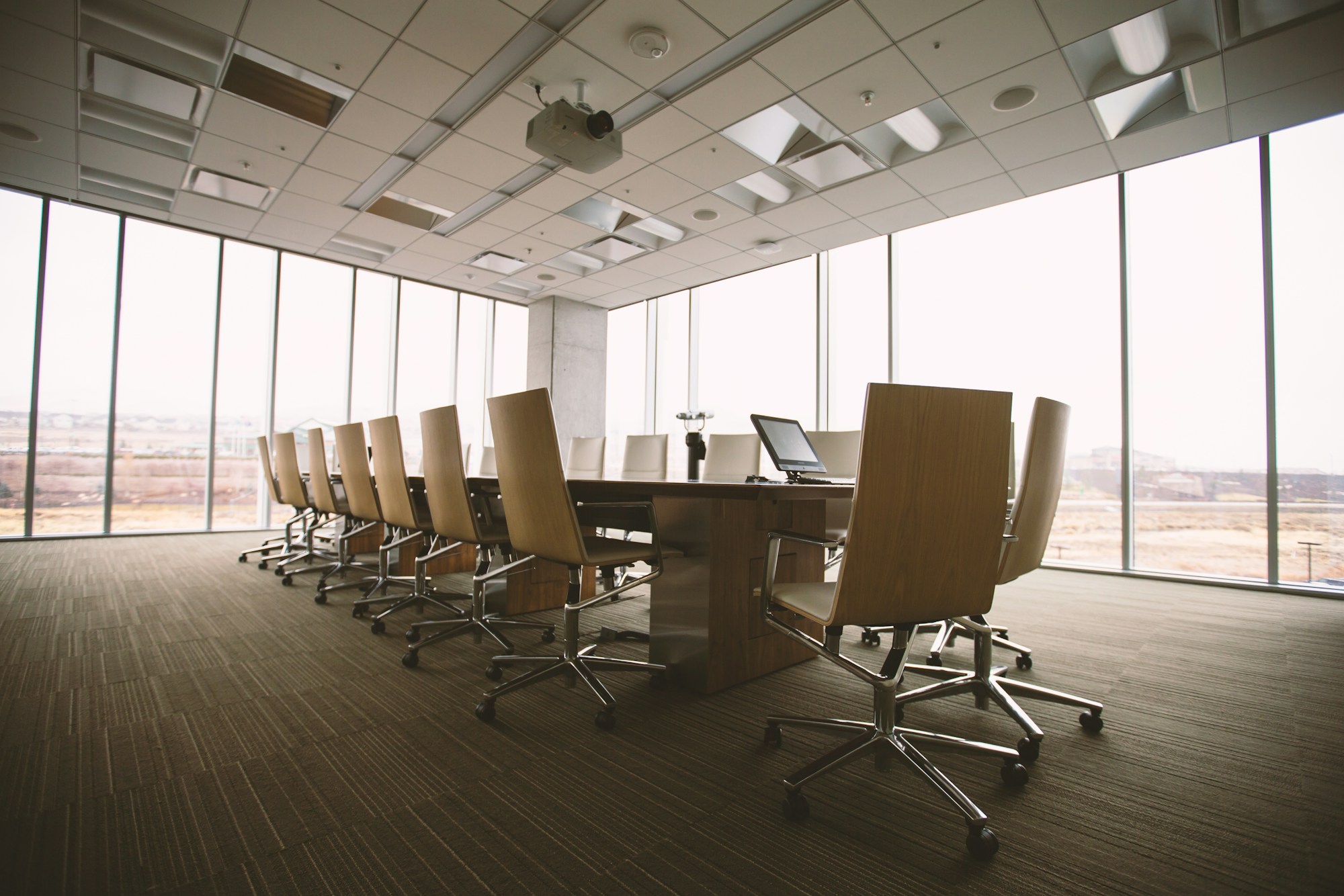 Une chaise vide au bout d'une longue table de conseil d'administration